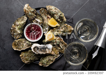 Fresh oysters with glasses of sparkling wine Fresh oysters with glasses of sparkling wine 109492397