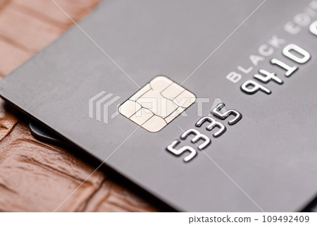 Closeup of black credit card on leather notepad 109492409
