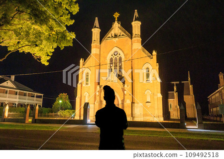 Illuminated church at night and the shadow of a man Illuminated church at night and the shadow of a man 109492518
