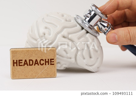 Using a stethoscope, the brain is diagnosed, next to it is a sign with the inscription - Headache 109493111