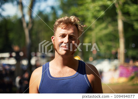 Portrait of man at music festival with smile, nature and relax in forest for concert event. Happiness, celebration at outdoor party with freedom and adventure, face of person with trees and sunshine. Portrait of man at music festival with smile, nature and relax in forest for concert event. Happiness, celebration at outdoor party with freedom and adventure, face of person with trees and sunshine. 109494077