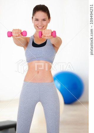 Woman, training and portrait for dumbbells in studio for health wellness, fitness and weight loss with exercise. Young person, happy and face with hand weights for tone muscle with strong body in gym Woman, training and portrait for dumbbells in studio for health wellness, fitness and weight loss with exercise. Young person, happy and face with hand weights for tone muscle with strong body in gym 109494251