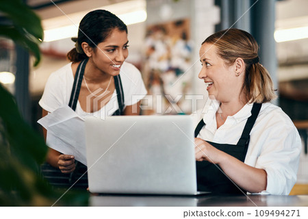 Small business owner working on a budget strategy or ordering stock online with an employee using a laptop in her store. Female entrepreneur talking to a worker about startup growth and sales 109494271