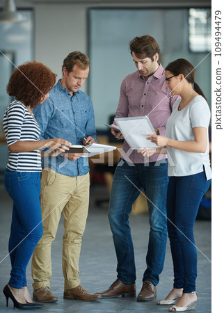A diverse group of business people talking in a meeting at an office. Serious, ambitious and professional work team of colleagues discussing and planning a marketing strategy at a startup company 109494479