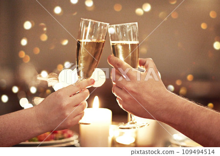 Cheers, toast and celebration with a couple on a romantic date for their engagement, anniversary or honeymoon. A candle lit dinner with wine glasses in the hands of a man and woman in a restaurant Cheers, toast and celebration with a couple on a romantic date for their engagement, anniversary or honeymoon. A candle lit dinner with wine glasses in the hands of a man and woman in a restaurant 109494514