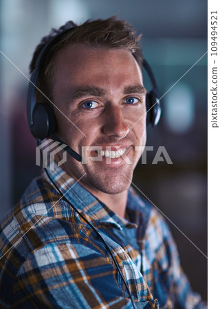 Happy call center agent smiling, ready to help a client on a phone call with good customer service and support. Close up portrait of a contact support worker consulting at his desk via his headset Happy call center agent smiling, ready to help a client on a phone call with good customer service and support. Close up portrait of a contact support worker consulting at his desk via his headset 109494521