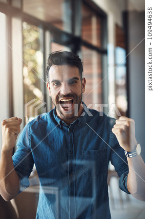 Winning, celebrating and cheering young successful male entrepreneur happy for success in his business. Portrait of an excited and startup owner feeling joy, cheerful and positive for his company 109494638