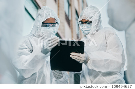 Hazmat wearing doctor and nurse working as a medical team and healthcare professionals at a quarantine site. Health and safety colleagues in protective gear ready to fight a virus or pandemic Hazmat wearing doctor and nurse working as a medical team and healthcare professionals at a quarantine site. Health and safety colleagues in protective gear ready to fight a virus or pandemic 109494657