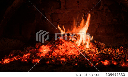 Logs of firewood burn out in the oven. Coals and flames in the fireplace. Logs of firewood burn out in the oven. Coals and flames in the fireplace. 109494880