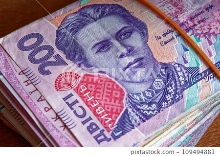 The precision of a bundle of Ukrainian money is evident in this scene, with a collection of 200-hryvnia banknotes, held together by a practical elastic band. The precision of a bundle of Ukrainian money is evident in this scene, with a collection of 200-hryvnia banknotes, held together by a practical elastic band. 109494881