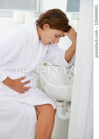 Vomiting, pregnant woman and morning sickness in bathroom, nausea and hand on stomach. Mirror reflection, moody and frustrated with illness, pregnancy and struggling with migraine pain on sink Vomiting, pregnant woman and morning sickness in bathroom, nausea and hand on stomach. Mirror reflection, moody and frustrated with illness, pregnancy and struggling with migraine pain on sink 109494981