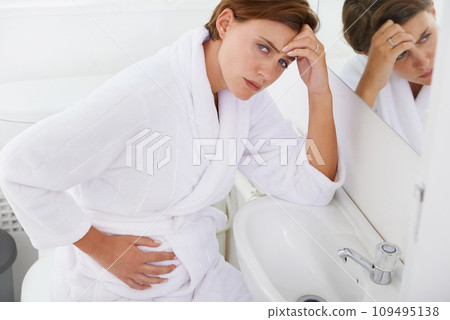 Nausea, pregnant woman and morning sickness in bathroom, unhappy and hand on stomach. Mirror reflection, moody and frustrated with illness, pregnancy and struggling with migraine pain on sink 109495138