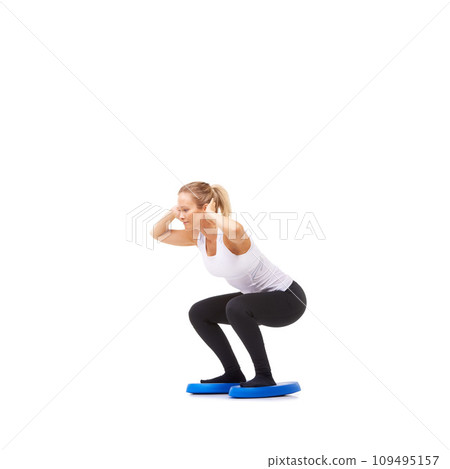 Balance, health and fitness with woman squat on disk in studio for workout, mindfulness or exercise. Wellness, challenge and training with person on white background for flexibility or aerobics 109495157