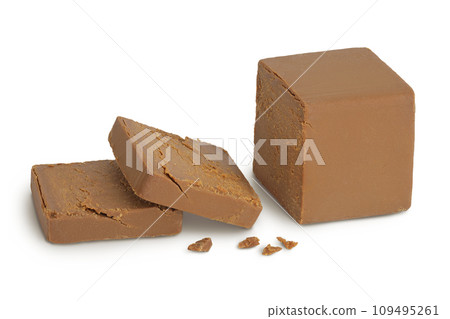 Brown cheese. Norwegian brunost isolated on white background with full depth of field Brown cheese. Norwegian brunost isolated on white background with full depth of field 109495261