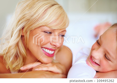 Happy, conversation and mother with child on bed for bonding, relaxing and spending time together. Smile, love and young mom chilling and resting with girl kid from Australia in bedroom of house. 109495262