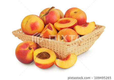 Ripe nectarine fruit with half in a wicker basket isolated on white background with full depth of field Ripe nectarine fruit with half in a wicker basket isolated on white background with full depth of field 109495265