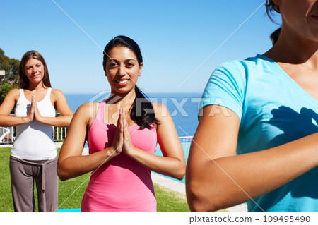 Namaste, yoga and portrait of women on grass together for fitness, exercise or mindfulness resort. Nature, pilates and happy friends at outdoor holistic health retreat for wellness, balance and zen. 109495490