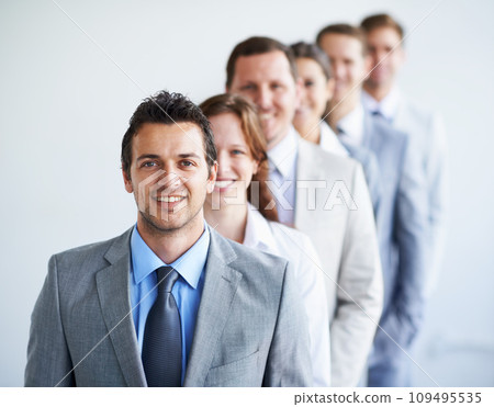 Happy man, portrait and leader with team in row, workforce, and ready for hiring process. Worker, corporate accountant in suit and professional in workplace, people in background and confident 109495535