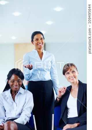 Businesswoman, smile and excited for presentation at conference, workshop or seminar in boardroom. Diverse group, happy people and listen to speaker, panel or discussion in formal, chic and fashion 109495644