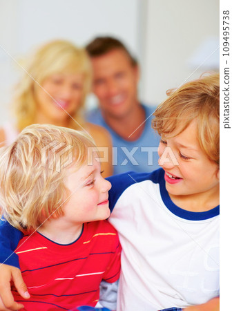 Hug, brothers and love for together on bed, relax wellness and happiness with sibling support in home. Boys, smile or embrace for care, family bonding or proud parents for morning peace in apartment Hug, brothers and love for together on bed, relax wellness and happiness with sibling support in home. Boys, smile or embrace for care, family bonding or proud parents for morning peace in apartment 109495738