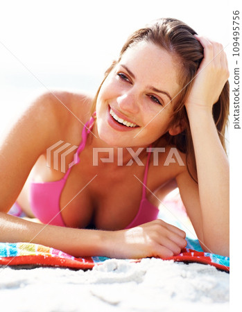 Relax, towel and happy woman in bikini on beach for summer vacation, travel adventure and sunshine on tropical island. Natural tan, sea and girl with smile at ocean holiday, sun and peace in Hawaii. 109495756