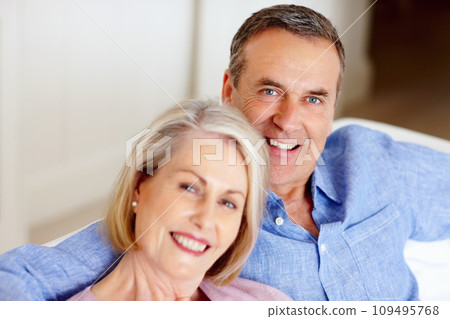 Smile, portrait or senior couple in home with love on sofa to bond or hug in a marriage commitment together. Happy, face or mature people in retirement with care or support in living room to relax 109495768