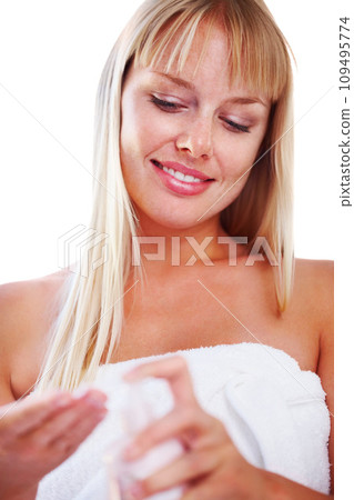 Woman, smile and lotion for skincare, bottle and white background or health, studio and wellness. Happy female person, cream and application or cosmetic product, dermatology and treatment or beauty 109495774