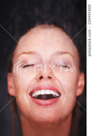 Shower, water splash and face of happy woman in a house for hygiene, fresh or stress relief closeup. Smile, bathroom and female person relax with cleaning, wellness or body care, skincare or routine 109495800