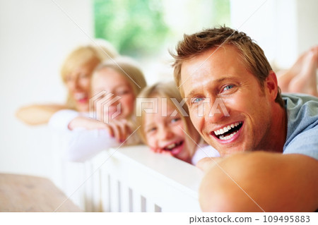 Portrait, smile and a family laughing on a bed together while in their home on a weekend morning. Face, love and a funny father, mother and kids in the bedroom of an apartment to relax for bonding Portrait, smile and a family laughing on a bed together while in their home on a weekend morning. Face, love and a funny father, mother and kids in the bedroom of an apartment to relax for bonding 109495883