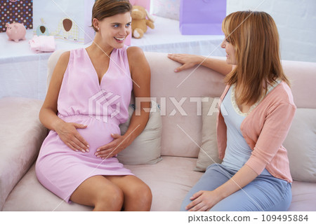 Women, babyshower and hands on stomach, living room couch and happy with baby moving. Pregnant lady, smile and excited for pregnancy, motherhood and celebrating child with friends in family home Women, babyshower and hands on stomach, living room couch and happy with baby moving. Pregnant lady, smile and excited for pregnancy, motherhood and celebrating child with friends in family home 109495884