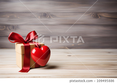 red heart gift box on wooden table 109495886