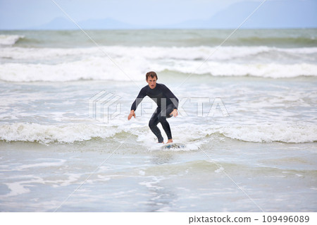 Surfer man, waves and board with balance, fitness and training for health, wellness and freedom in summer. Person, surfing and outdoor for sports, exercise and adventure at sea, ocean and sunshine 109496089