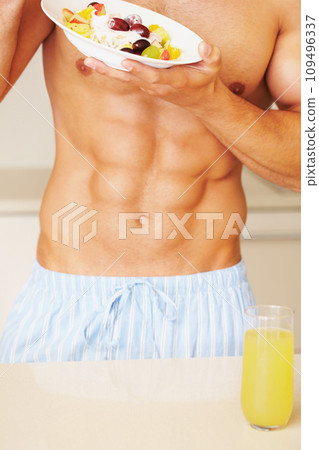 Closeup, man and bowl with fruit salad in kitchen for breakfast, healthy and eating for diet. Male person, body and shirtless with fresh, organic or meal for weight loss, calories and juice for care Closeup, man and bowl with fruit salad in kitchen for breakfast, healthy and eating for diet. Male person, body and shirtless with fresh, organic or meal for weight loss, calories and juice for care 109496337