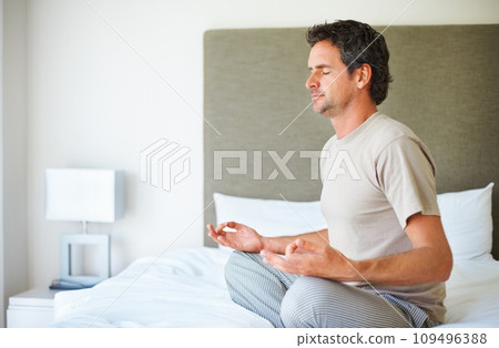 Bed, morning and man with meditation, yoga and peace with routine, fitness and wellness. Bedroom, home and person with breathing, energy or spiritual with peace, balance and zen with health or lotus Bed, morning and man with meditation, yoga and peace with routine, fitness and wellness. Bedroom, home and person with breathing, energy or spiritual with peace, balance and zen with health or lotus 109496388