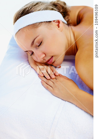 Spa, massage and woman sleeping ready for back care for wellness and health in a salon. Resort, masseuse table and calm female person with zen and pamper treatment for beauty and stress relief 109496389