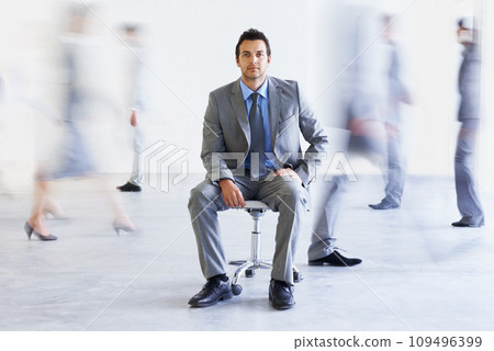 Portrait, chair and business man in busy office, workplace or corporate company. Motion blur, serious professional and employee coworking, confident lawyer and attorney in suit for career 109496399