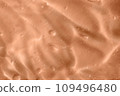 Texture of transparent pastel colored gel with air bubbles and waves. Trendy color 2024 Peach Buzz. Liquid beauty product closeup. Skincare, body care, wellness, beauty. Backdrop, flat lay 109496480
