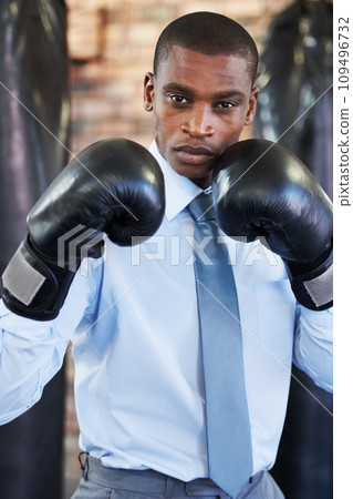 Man, portrait and boxing gloves in suit confident for manager job, ready for business or corporate competition. Black person, face and fighter gear for office achievement, career promotion at work 109496732