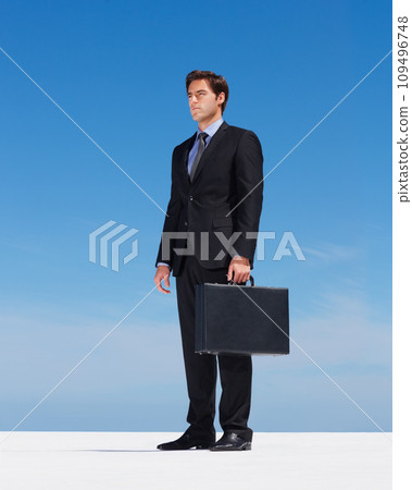 Briefcase, sky and young businessman thinking on building rooftop in the city with serious expression. Idea, bag and professional male person from Canada standing and dreaming or planning for work. 109496748