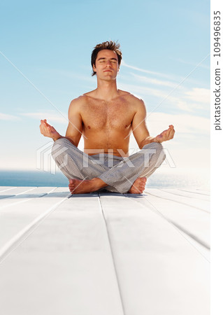 Outdoor, yoga and meditation with man, peace and breathing with health, wellness and relax. Person, yogi or guy with lotus position, spiritual or freedom with energy, fitness or exercise with workout 109496835