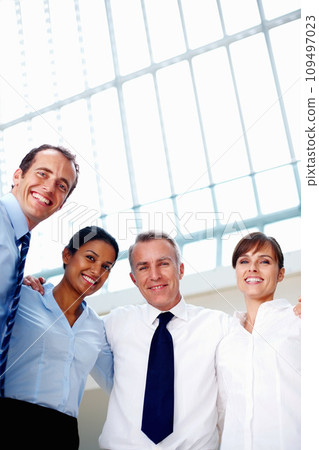 Businesspeople, portrait and happy with low angle in office for hug, together or embrace for unity in support. Corporate, diverse group and team with smile for international, about us or partnership 109497023