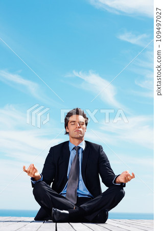 Meditation, thinking and business man on blue sky for relaxing, positive mindset and solution. Corporate person, professional and worker outdoors in yoga pose for wellness in career, work and job 109497027