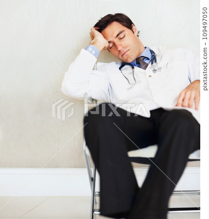 Burnout, fatigue and sleeping doctor, man or surgeon rest after medical cardiology, wellness services or exhausted. Eyes closed, relax medic and professional nurse tired in clinic healthcare hospital 109497050