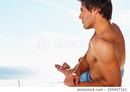 Sea, relax and the body of a man on a deck with a view of the water in summer while on holiday or vacation. Freedom, ocean or sky and a shirtless young tourist tanning outdoor on a pier with space 109497161