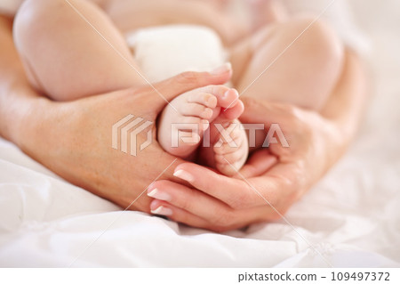 Woman, child and feet closeup for love connection or childhood bonding, motherhood or newborn. Female person, infant and toes or care support for kid growth development, parent trust or nurture youth 109497372
