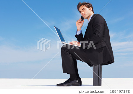 Laptop, phone call and business man on briefcase in conversation, listening or communication on blue sky mockup space. Computer, mobile chat and serious lawyer networking, discussion or legal advice 109497378