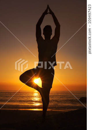 Silhouette, man and praying with hands for yoga, health and wellness on beach with sunset and zen. Person, shadow and pilates or namaste for balance, mindfulness and healthy body by ocean or sea Silhouette, man and praying with hands for yoga, health and wellness on beach with sunset and zen. Person, shadow and pilates or namaste for balance, mindfulness and healthy body by ocean or sea 109497423