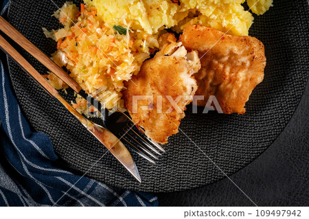 Fried cod fillet served. 109497942