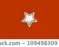 Christmas five pointed golden star on orange background. Christmas decoration. 109498309