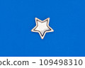 Christmas five pointed golden star on blue background. Christmas decoration. 109498310